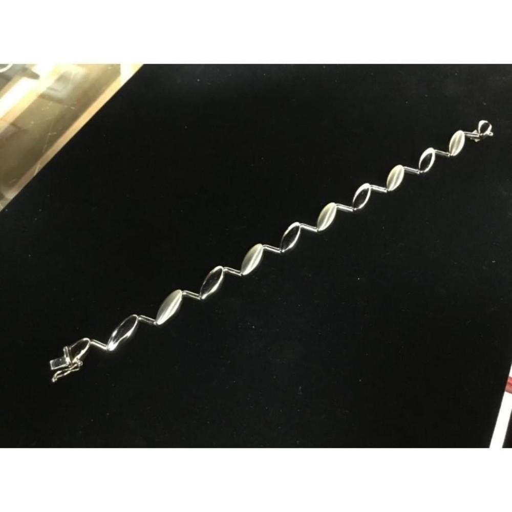 Custom Designed 14K White Gold Brilliance Woman's Bracelet: A Custom Designed 14K White Gold Brilliance Woman's Bracelet that has a look to its own. Adding a little flavor to your style with this 14K White Gold Bracelet can spice things up in a hurry. Italian 