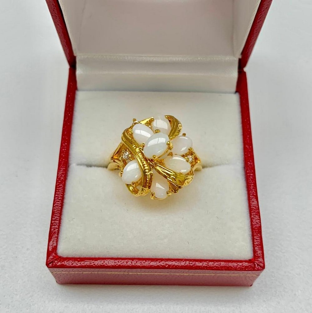 Ladies .56ct Oval Cut White Opal in 14KT Gold Plated Ring: Ladies .56ct size 7 Oval Cut White Opal in 14KT Gold Plated Ring, each stones Carat weight is .08. In mystical circles, opal is considered a stone representing hope, innocence and purity. It has stron