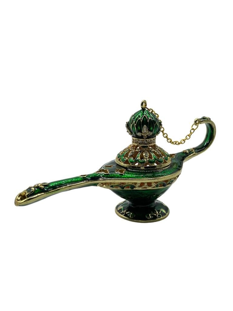 Green Genie Lamp Trinket Box: Green Genie Lamp Trinket Box A captivating piece with a lustrous green finish, adorned with sparkling jewels. Its perfect for storing treasures or as a decorative accent, adding a touch of magic to an