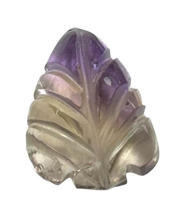 5ct Ametrine Leaf Carving Gemstone: 5ct Ametrine Leaf Carving Gemstone Ametrine creates a mesmerizing blend of lavender and golden hues, resulting in a breathtaking play of colors within the intricate leaf design. Origin: Bolivia Untrea