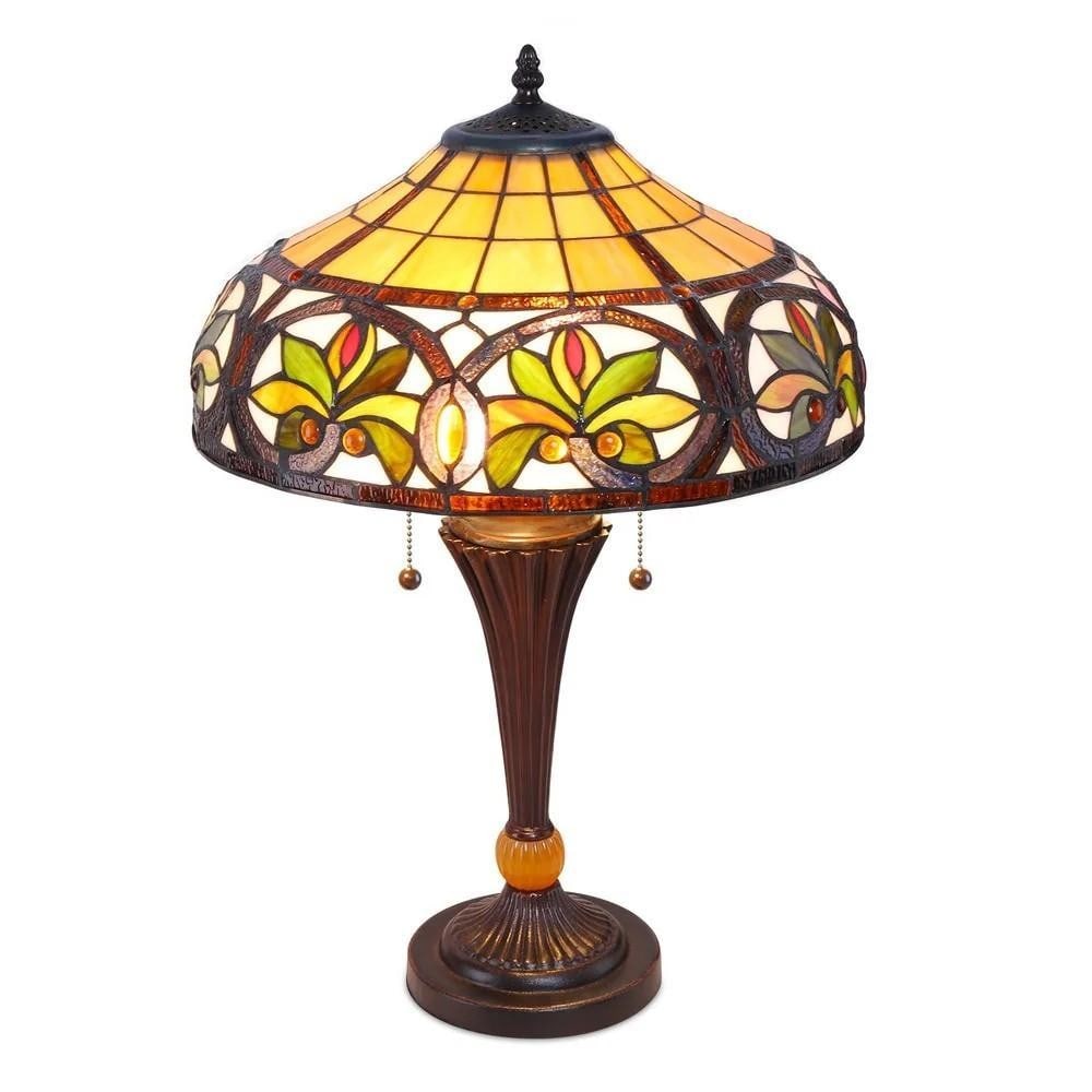 Sunrise Glow Tiffany-Style Stained Glass Table Lamp: Sunrise Glow Tiffany-Style Stained Glass Table Lamp Table lamp featuring a shade made of hand-cut stained glass in red, blue, and green tones. The lamp has a copper base and measures 16 inches wide by