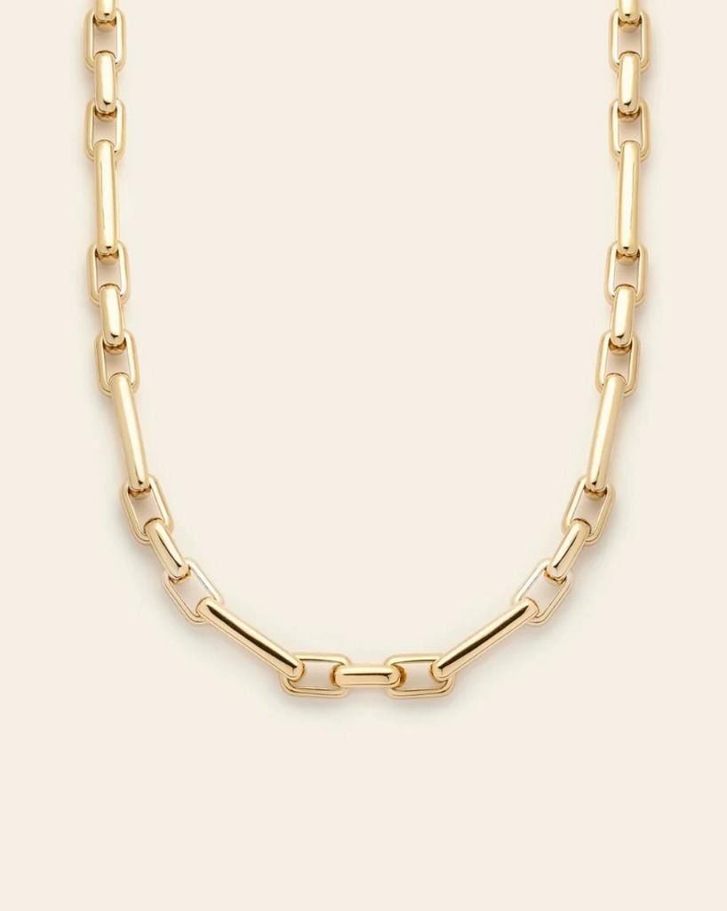 Golden Radiance Chain Necklace: Golden Radiance Chain Necklace All eyes on her. This chain shines effortlessly on its own or layered with your favorite pieces. Crafted in 14k gold plated over brass, it features alternating smaller