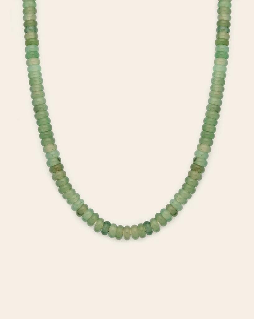 Aventurine Gemstone Necklace: Aventurine Gemstone Necklace Polished with an organic edge, the Aventurine Gemstone Necklace is designed to shine solo or anchor a layered look with chains and charms. Featuring smooth aventurine