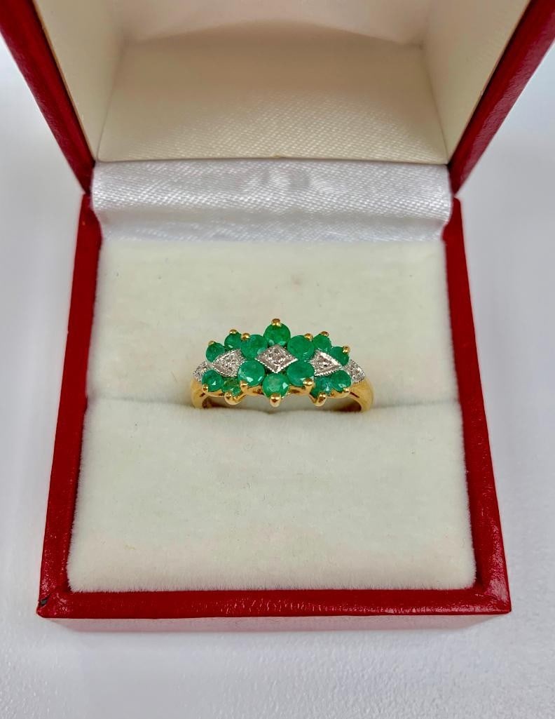Detailed Ladies Size 7, 10k Gold, Emerald and Diamond Ring: This ring is completed with seven 0.04ct round cut emerald stones, and is mediated by four small, round cut diamonds. All set in a lustrous 10k gold ring. Please view photos for further details. Gemst