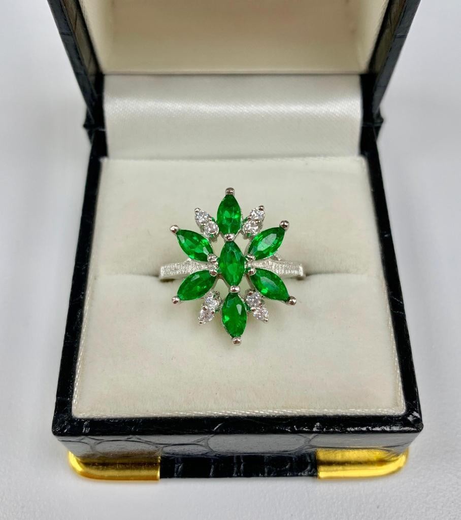 Lovely Ladies Size 7 Green Tourmaline and Sterling Silver Ring: A symmetrically designed ring, with Seven 0.18ct Marquise cut green Tourmaline Stones. Bordered by eight round cut crystals. all set in a sleek 925 Sterling Silver ring. Please view photos for further
