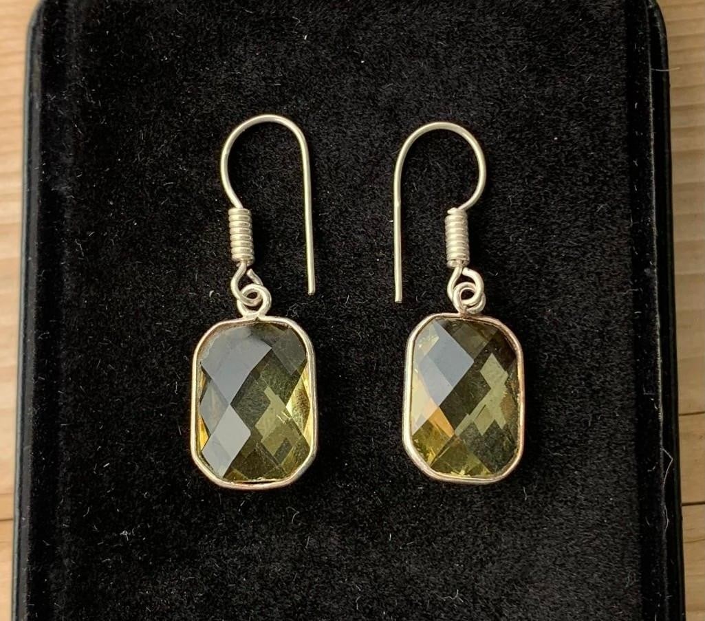 Cushion-Cut Citrine Dangle Earrings in a Silver-Tone Setting: Cushion-Cut Citrine Dangle Earrings in a Silver-Tone Setting Add a touch of golden elegance with these stunning dangle earrings, each featuring a large cushion-cut citrine stone that catches the light