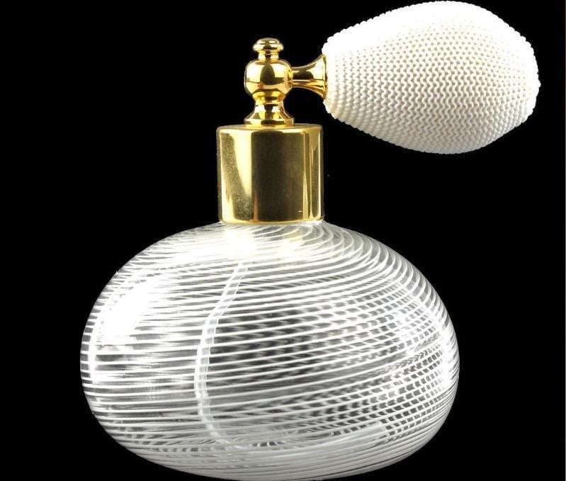 White Filigree Scent Atomizer Murano Glass Bottle: White Filigree Scent Atomizer Murano Glass Bottle Introducing our Little White Bottle, a delicate creation handmade with the meticulous technique of blown glass and intricate filigree. Crafted by the 