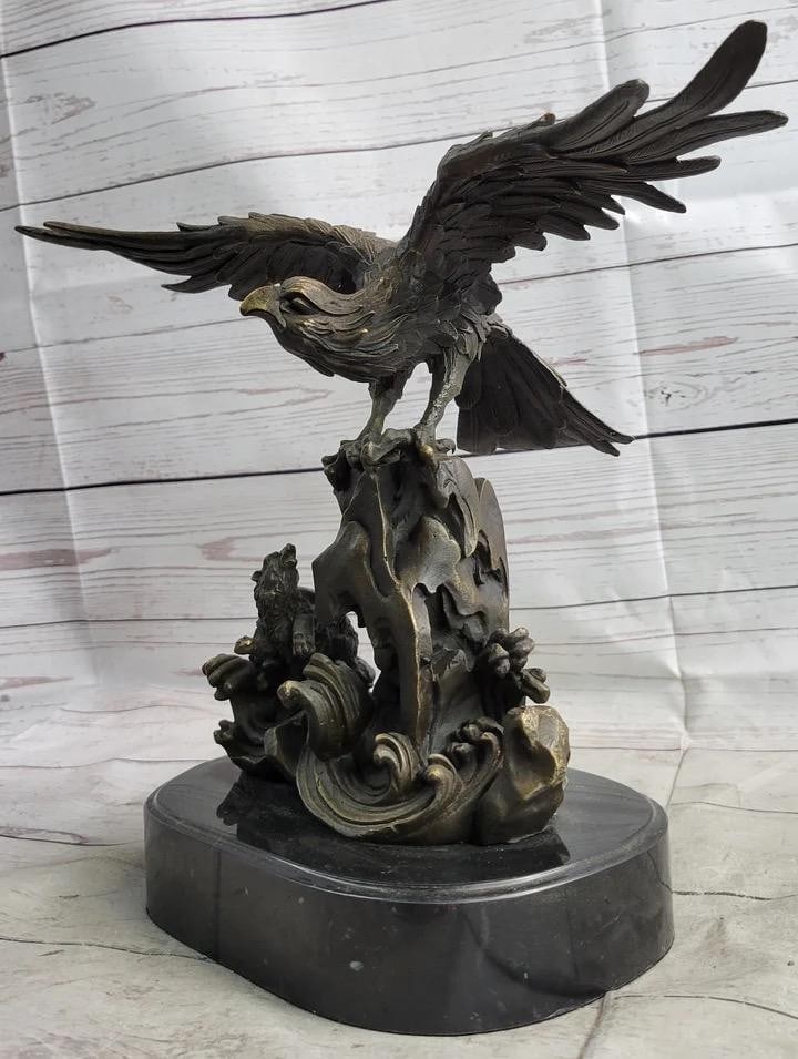 Original Eagle Landing on Waves Bronze Sculpture - 13'' x 13'': Original Eagle Landing on Waves Bronze Sculpture - 13" x 13" This bronze sculpture depicts a bird with its wings open, standing on a fluid-like bronze plinth. The bird appears to be absorbing it