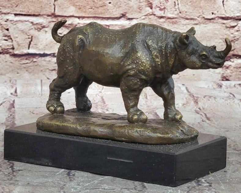 African Rhinoceros Bronze Sculpture: African Rhinoceros Bronze Sculpture The horn of a rhinoceros is the animals unique and defining physical characteristic other than its massive size. This piece is of rhinoceros head yet it fully depic