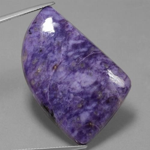 48.2ct Violet ''Purple Shader'' Charoite Gem Stone: 48.2ct Violet Charoite Gemstone This beautiful violet gemstone is an overall stress buster, giving off serene energy this Charoite is overall great for the mind and body health. Size: 35.2 x 23.9 x 5.