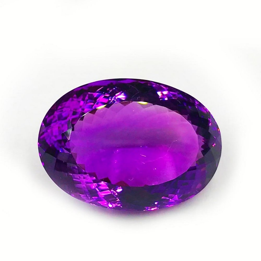 95.72ct Faceted Amethyst Oval Gemstone: Faceted Amethyst Oval With a deep and beautiful shade of purple, this gem is absolutely mesmerizing Size- 35.3 x 25.2 mm, Weight- 95.72 ct View photos for further details.