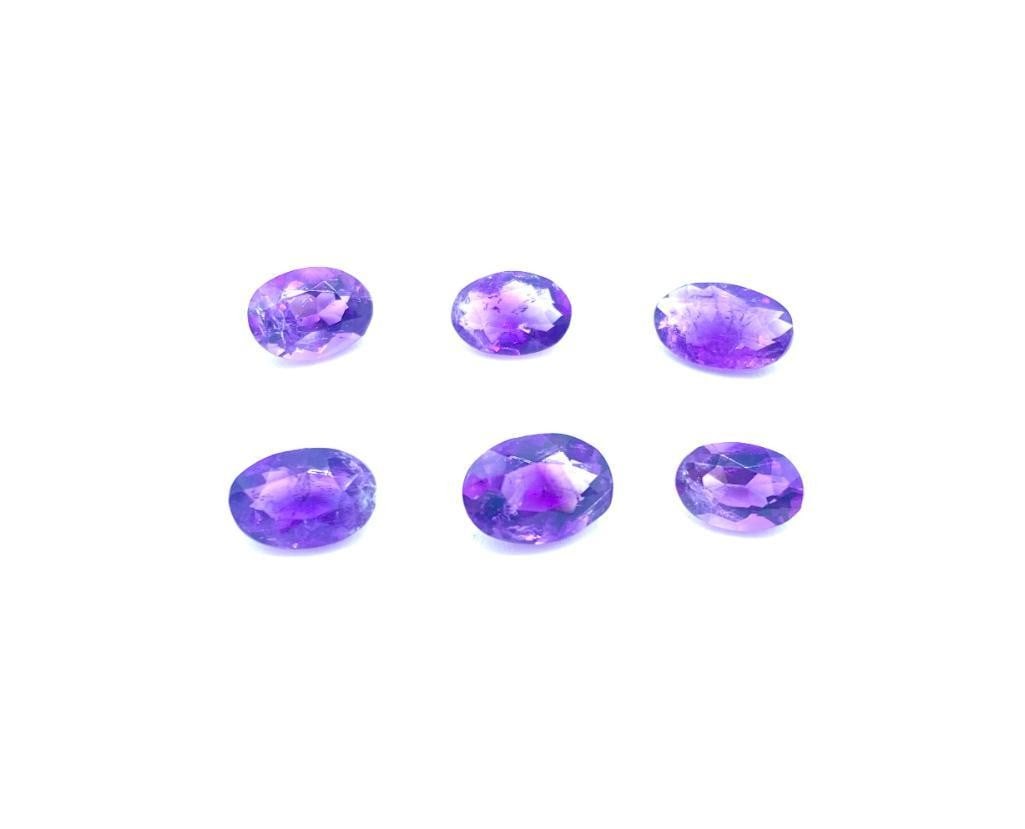 9ct Oval Cut Deep Purple Amethysts: 9ct Oval Cut Deep Purple Amethysts This lot contains 6 oval cut Amethyst stones, each at 1.63ct Raw Dimension: 8 x 6 x 4mm Total Carat Weight: 9.78ct Treated: No Please view photos for furhter