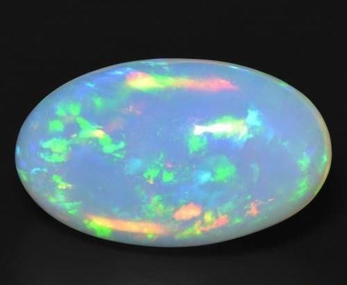 18.55 ct Oval Cabochon Rainbow Bluish-White Opal Gemstone: 18.55 ct Oval Cabochon Rainbow Bluish-White Opal Gemstone Introducing our Oval Cabochon Rainbow Bluish-White Opal Gemstone - a celestial dance of color encapsulated in a timeless elegance. Carefully