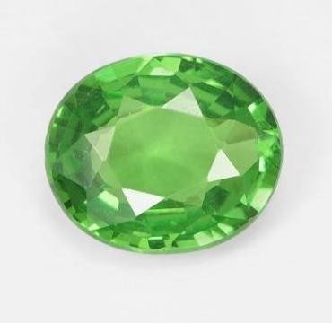 0.69 ct Oval Cut Shamrock Medium Green Tsavorite Garnet Gemstone: 0.69 ct Oval Cut Shamrock Medium Green Tsavorite Garnet Gemstone Introducing our enchanting 0.69 ct Oval Cut Shamrock Medium Green Tsavorite Garnet Gemstone-a verdant masterpiece that embodies the