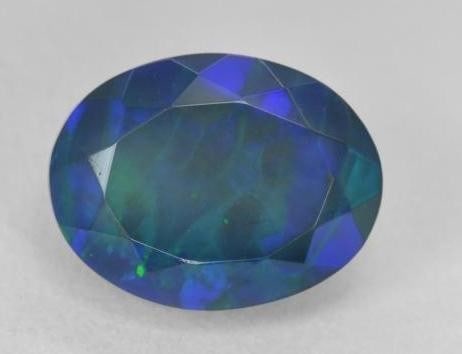 3.52 ct Oval Cut Faceted Celestial Galactic Black Opal Gemstone: 3.52 ct Oval Cut Faceted Celestial Galactic Black Opal Gemstone Embark on a cosmic journey with the Oval Cut Faceted Celestial Galactic Opal Gemstone-a mesmerizing celestial treasure that