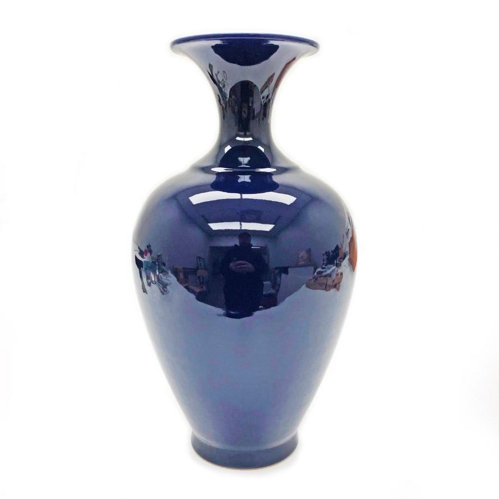 Asian Ox Blood Bulbous Vase: Asian Ox Blood Bulbous Vase. This monochrome vase has a bulbous body and a short cylindrical narrow neck. This vase embodies the continuation of centuries of Asian ceramic traditions. Oxblood ceramics