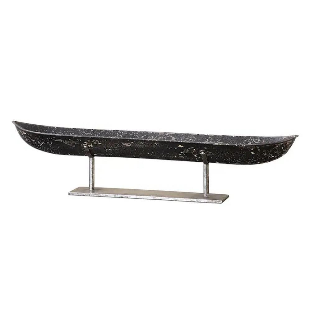 River Voyage Sculpture: River Voyage Sculpture This lovely boat sculpture is crafted from heavily distressed, aged black metal, featuring silver undertones and resting on a silver stand. It serves as a striking figurine