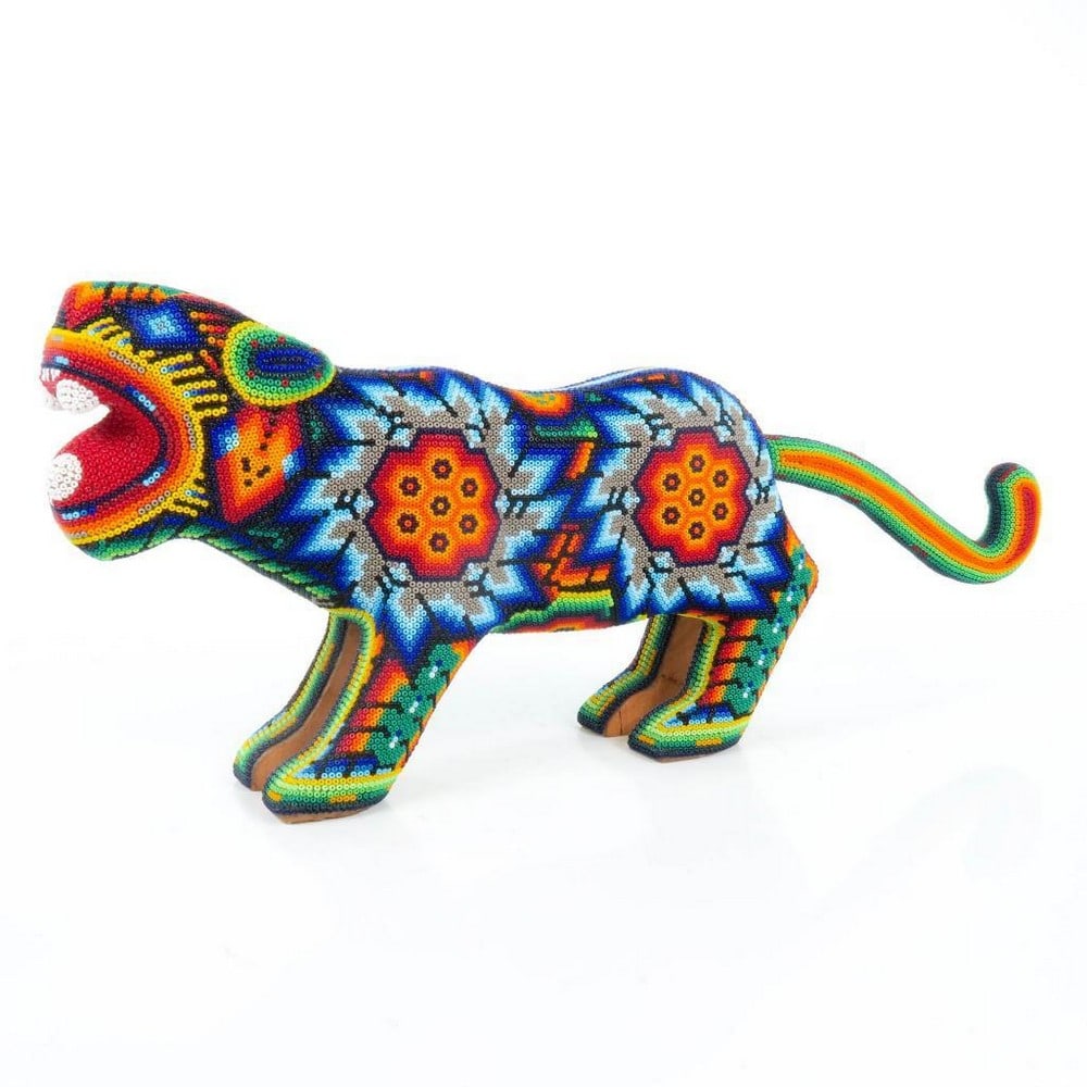 Huichol Beaded Multicolour Jaguar Sculpture: Huichol Beaded Multicolour Jaguar Sculpture Exquisite handcrafted by the indigenous Huichol community of Jalisco, this magnificent beaded deer showcases their exceptional artistry. Crafted from wood,