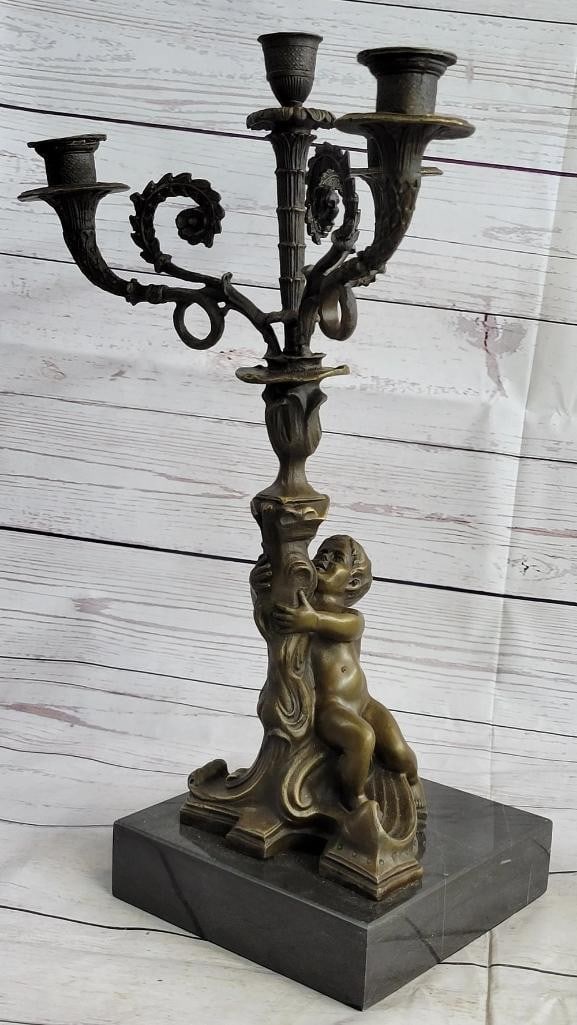 Playful Toddler Bronze Candle Holder Sculpture - 16'' x 8'': Playful Toddler Bronze Candle Holder Sculpture - 16" x 8" This charming bronze sculpture features an innocent toddler playfully gripping the base of a four-piece candle holder. The nude figure