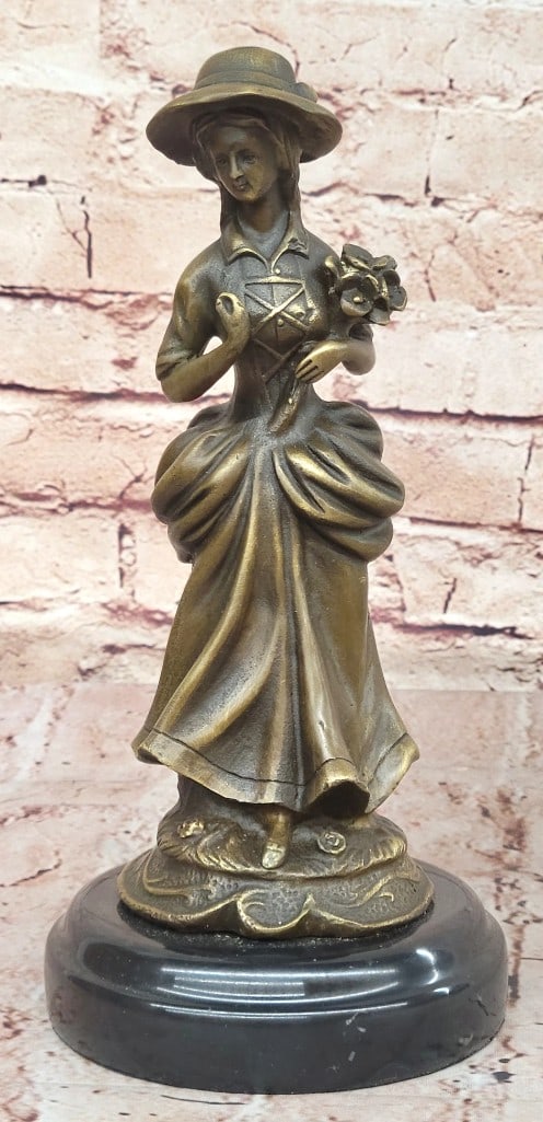 Victorian Lady Holding Flowers Original Bronze Statue - 10.5'' x 4.5'': Victorian Lady Holding Flowers Original Bronze Statue - 10.5" x 4.5" Milo's Victorian Woman Bronze Sculpture embodies the grace and refinement of the era. Poised in a flowing gown, she delicatel