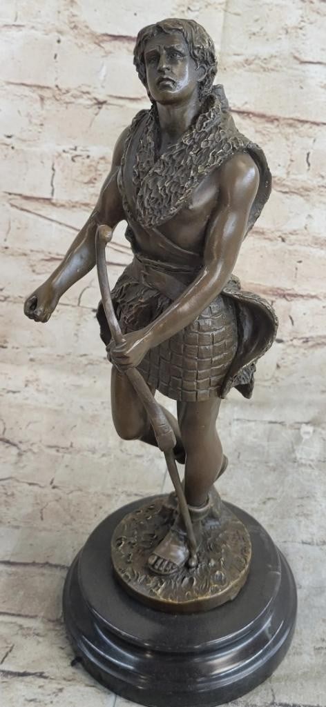 Guardian of the Village Bronze Statue Inspired by A. Bronier - 14.5'' x 5.5'': Guardian of the Village Bronze Statue Inspired by A. Bronier - 14.5" x 5.5" This striking bronze statue depicts a powerful nude male figure, poised as a vigilant guardian with a bow and arrow. T