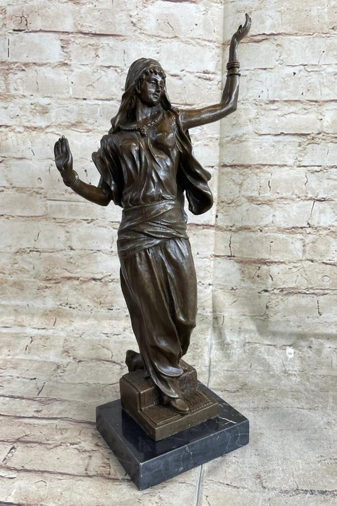 Arabian Dancer Inspired Bronze Statue - 16.5'' x 9'': Arabian Dancer Inspired Bronze Statue - 16.5" x 9" This bronze sculpture portrays an Arabian woman in a graceful dance, fully immersed in the music from a nearby radio. Her flowing dress and det
