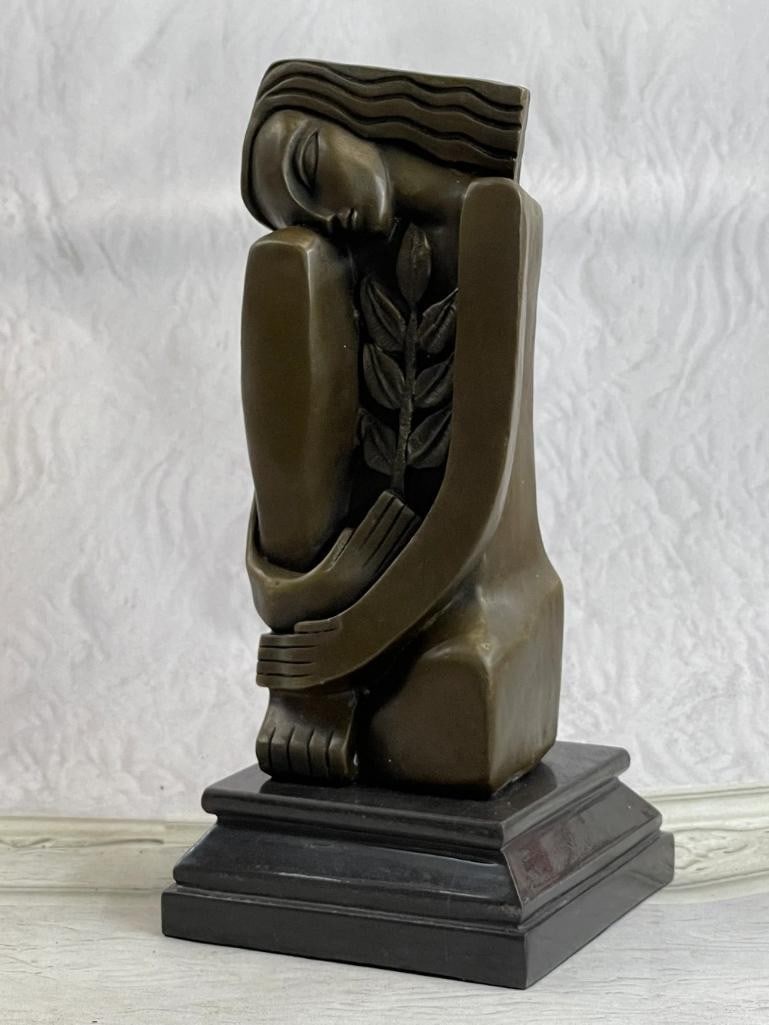 Abstract Lounging Women Inspired Bronze Statue - 10'' x 5'': Abstract Lounging Women Inspired Bronze Statue - 10" x 5" This abstract bronze statue depicts a lounging woman with elongated and curved forms, creating a sense of fluidity and movement. The var