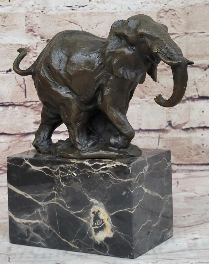 Noble Elephant Original Bronze Statue - 9'' x 8'': Noble Elephant Original Bronze Statue - 9" x 8" This original bronze statue depicts a noble elephant in mid-stride, with its trunk curled upwards and ears flared out, suggesting movement and vit
