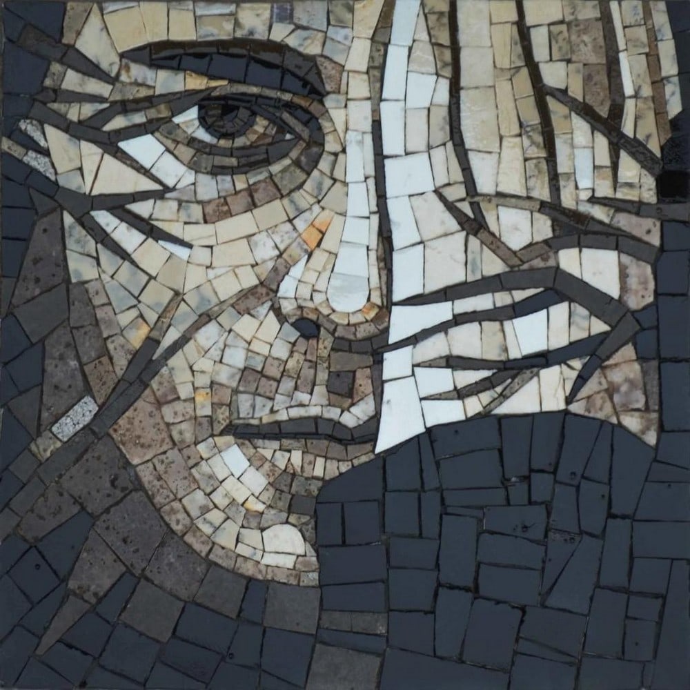 Abstract Man Face Mosaic Artwork: Abstract Man Face Mosaic Artwork A handcrafted mosaic artwork portraying a striking abstract depiction of a man's face, with one hand partially obscuring his features and tree-branch motifs adding