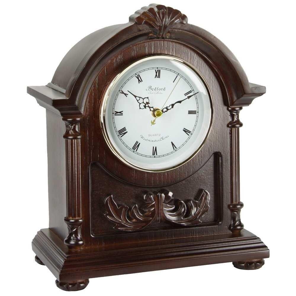Dark Finish Quartz Mantel Clock: Dark Finish Quartz Mantel Clock This exquisite mantel clock features a dark-finished hardwood case with a glass-enclosed dial. The bright dial highlights Roman numerals with black spade hands and