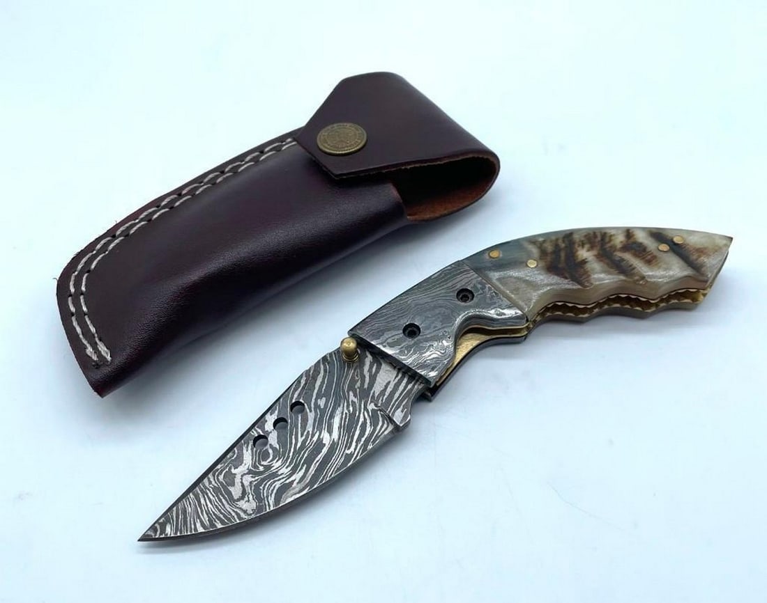 Dooms Eternal Folding Damascus Knife: Dooms Eternal Folding Damascus Knife. Damascus Steel Blade with 256 Layers on it. HARDNESS 56-60 H R C VERY HIGH QUALITY GENUINE LEATHER SHEATH View photos for further details.