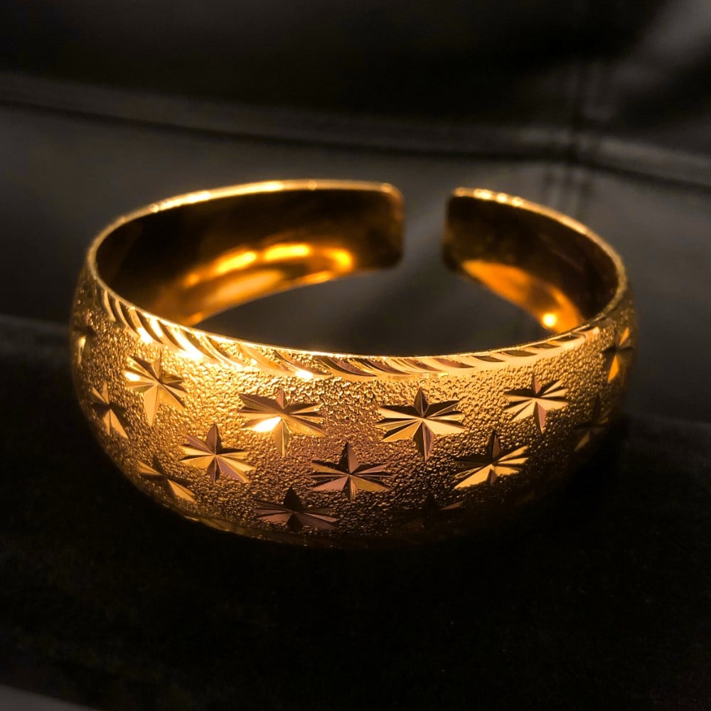 Gold-Colored Bangle Bracelet: Gold-Colored Bangle Bracelet A timeless gold-colored bangle bracelet that adds a touch of elegance to any outfit. Its sleek and polished design makes it perfect for both everyday wear and special
