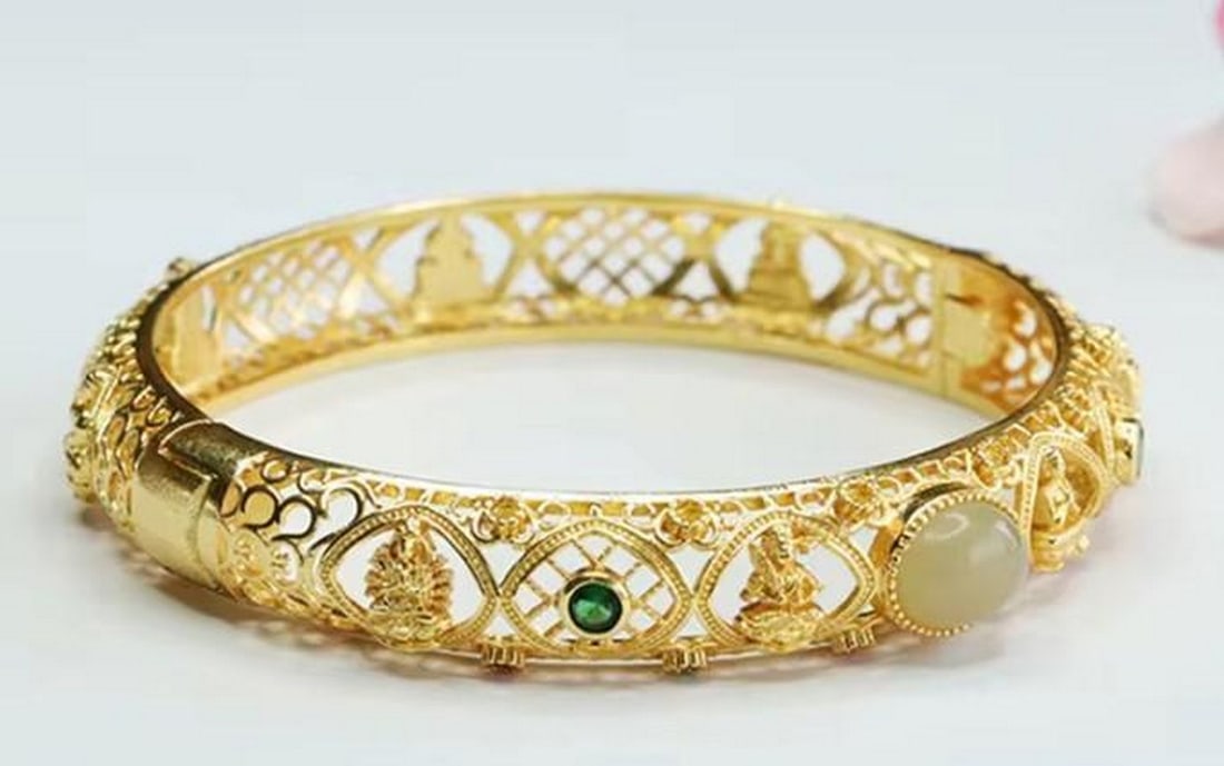 Gold Plated Jade Bangle: Gold Plated Stone Jade Bangle Crafted with a polished jade centerpiece and a warm gold-plated finish, this bangle offers a harmonious blend of sophistication and natural beauty. Lightweight yet eye-ca