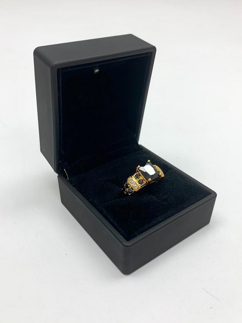 Black Stone Ring: Black Stone Ring Make a statement with this stunning ring featuring a bold black stone at its center. The band is elegantly lined with alternating black and white crystals on either side, adding