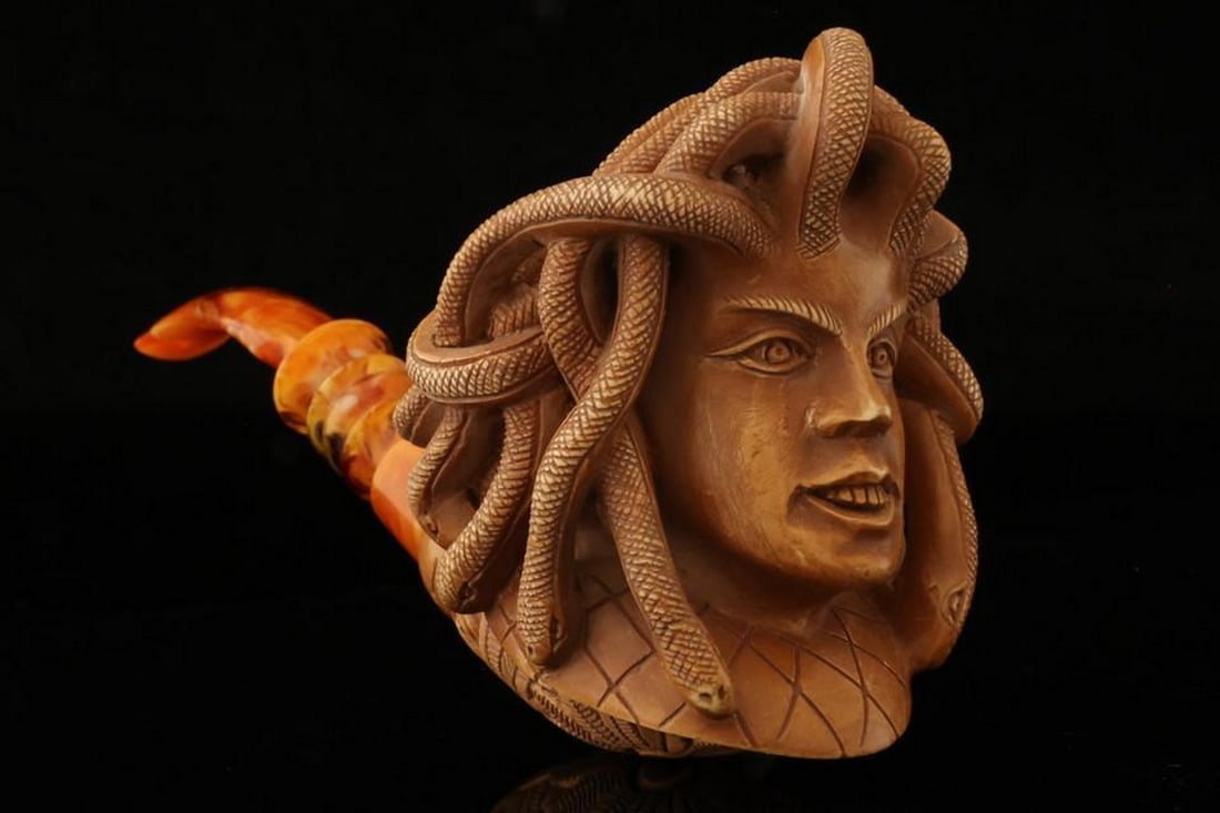 Medusa Sculpted Block Meerschaum Pipe with Fitted Case: Medusa Sculpted Block Meerschaum Pipe with Fitted Case This oversized hand-carved meerschaum pipe features an intricate Medusa design, showcasing exceptional artistry and detailed craftsmanship. The b