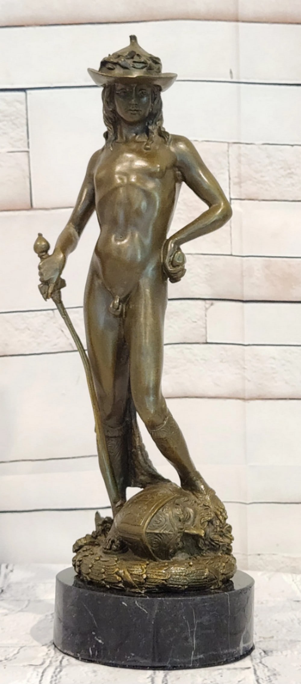 David Bronze Sculpture by Miguel Lopez - 12" x 4": David Bronze Sculpture by Miguel Lopez - 12" x 4" Introducing a Classical Bronze Sculpture: This depiction of David is meticulously handcrafted with careful attention to detail. The figure is 