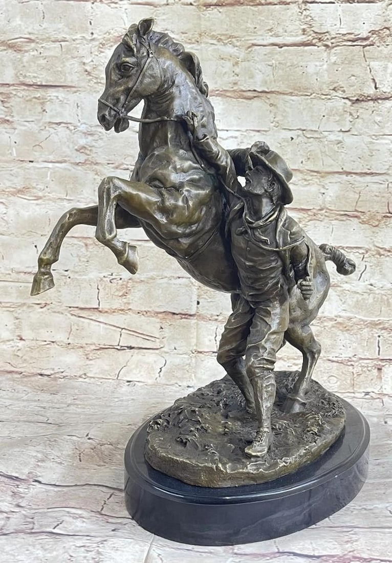 Large Horse & Man Bronze Sculpture: Large Horse & Man Bronze Sculpture The Western cowboy grabs the reins on his horse. The excited horse rears in a heated moment, lifting its front legs in the air. The brave cowboy is attempting calm t