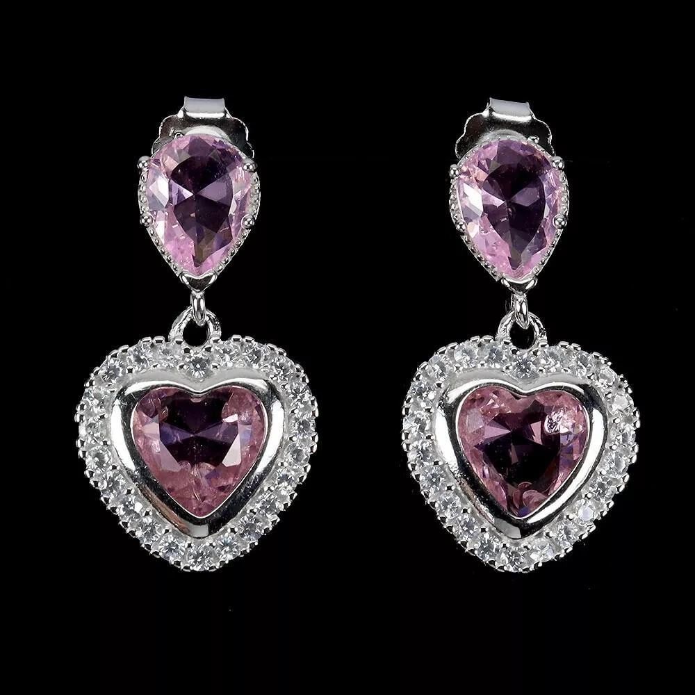 Heart-Shaped AAA Pink Simulated CZ Earrings in 925 Sterling Silver: Heart-Shaped AAA Pink Simulated CZ Earrings in 925 Sterling Silver These enchanting earrings feature heart-shaped AAA pink simulated cubic zirconia stones, set in 925 sterling silver. The 8mm stones o