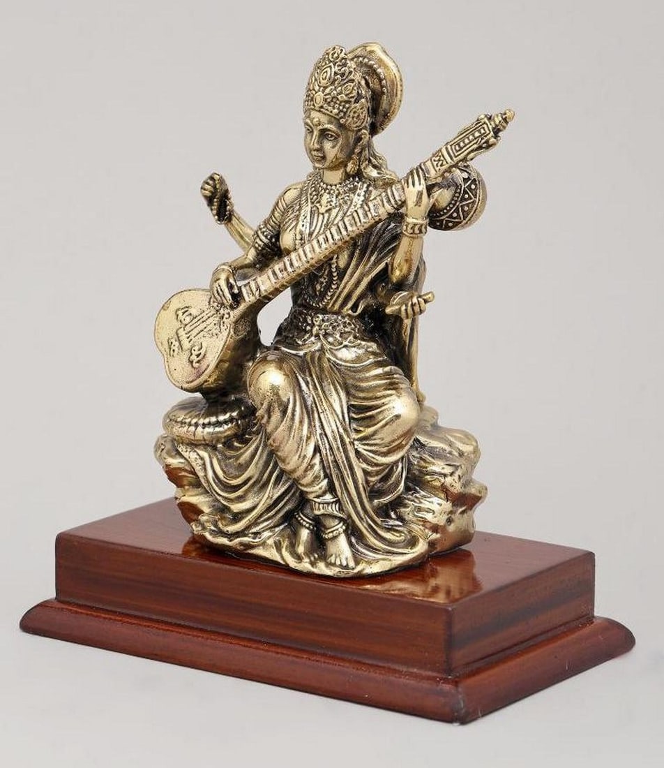 4" Goddess Kali Seated on Wooden Base: 4" Goddess Kali Seated on Wooden Base This 4" brass idol beautifully depicts Goddess Kali, the powerful Hindu deity of transformation, protection, and maternal love, seated gracefully on a woo