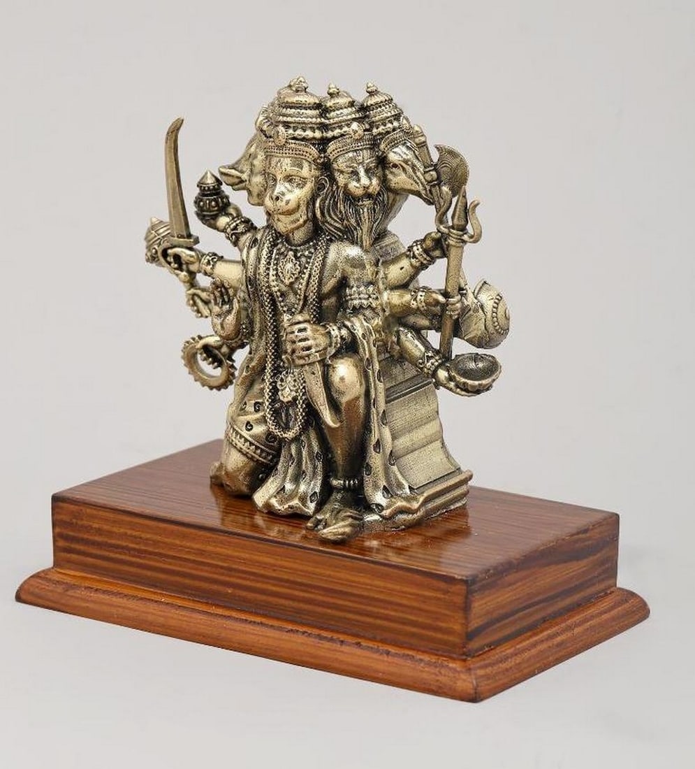 5" Panchamukhi Lord Hanuman Brass Statue on Wood Base: 5" Panchamukhi Lord Hanuman Brass Statue on Wood Base This 5" brass statue depicts Panchamukhi Hanuman, the five-faced form of the revered deity symbolizing strength, courage, and protection. 