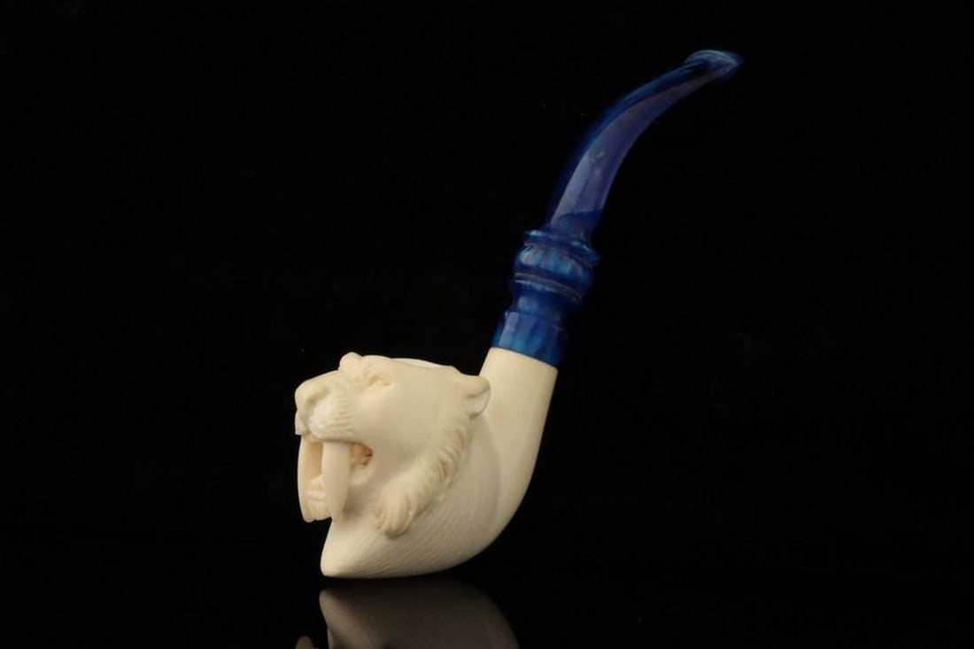 Saber Tooth Tiger Carved Block Meerschaum Pipe with Fitted Case: Saber Tooth Tiger Carved Block Meerschaum Pipe with Fitted Case This hand-carved block meerschaum pipe features a detailed saber tooth tiger design, highlighting the artistry and craftsmanship of