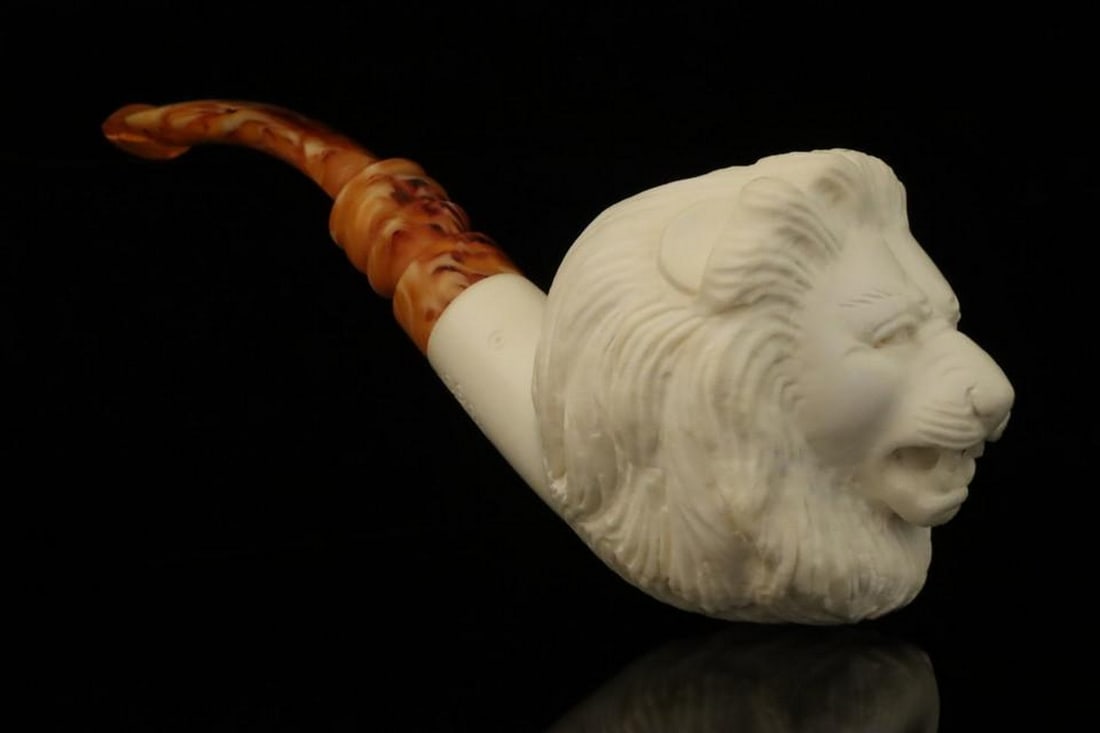 Lion Carved Block Meerschaum Pipe with Fitted Case: Lion Carved Block Meerschaum Pipe with Fitted Case This hand-carved block meerschaum pipe features a detailed lion design, demonstrating the artistry and craftsmanship of traditional meerschaum work.