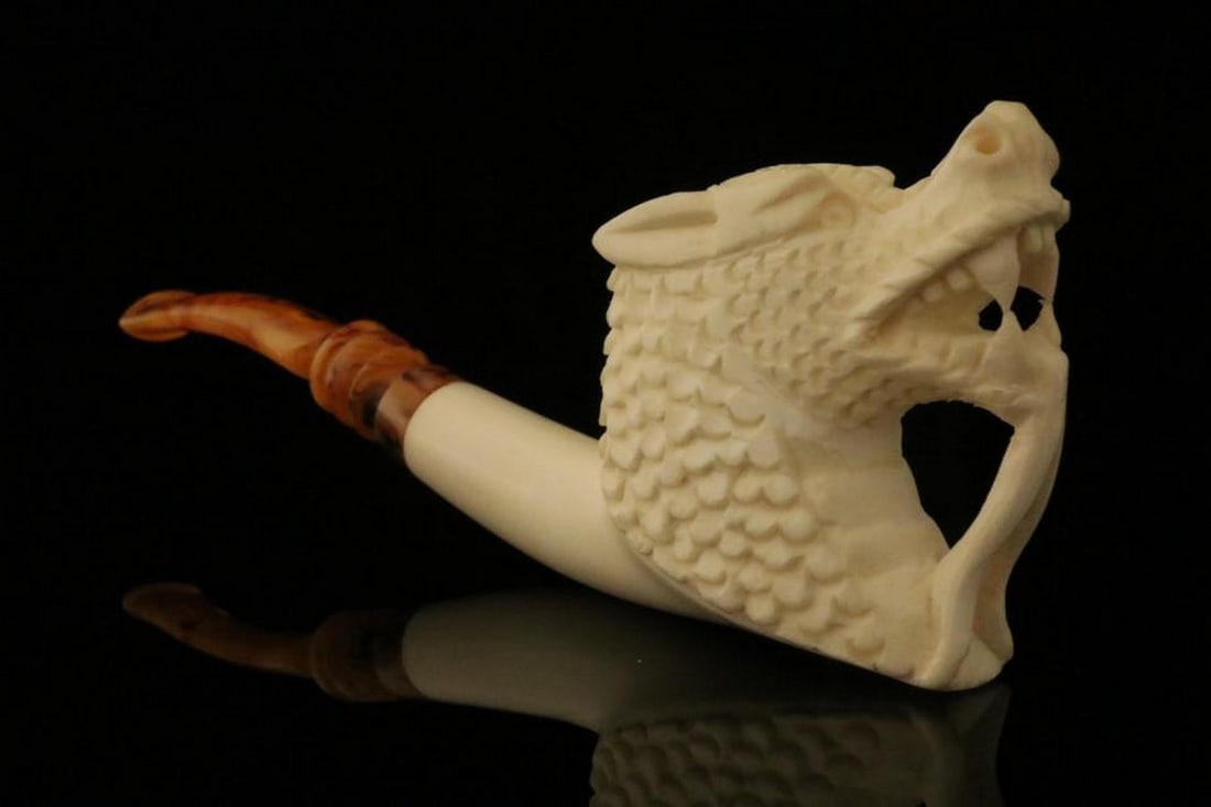 Dragon Block Meerschaum Pipe with Fitted Case: Dragon Block Meerschaum Pipe with Fitted Case This hand-carved meerschaum pipe features a detailed dragon design, capturing the power and elegance of the legendary creature. Naturally dipped in hot