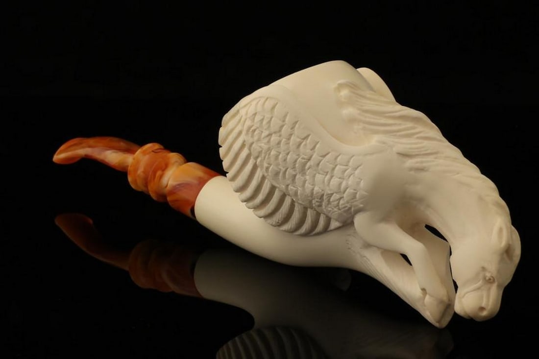 Pegasus Sculpted Block Meerschaum Pipe with Fitted Case: Pegasus Sculpted Block Meerschaum Pipe with Fitted Case This hand-carved meerschaum pipe features a detailed Pegasus design, showcasing the graceful form of the legendary winged horse. Naturally