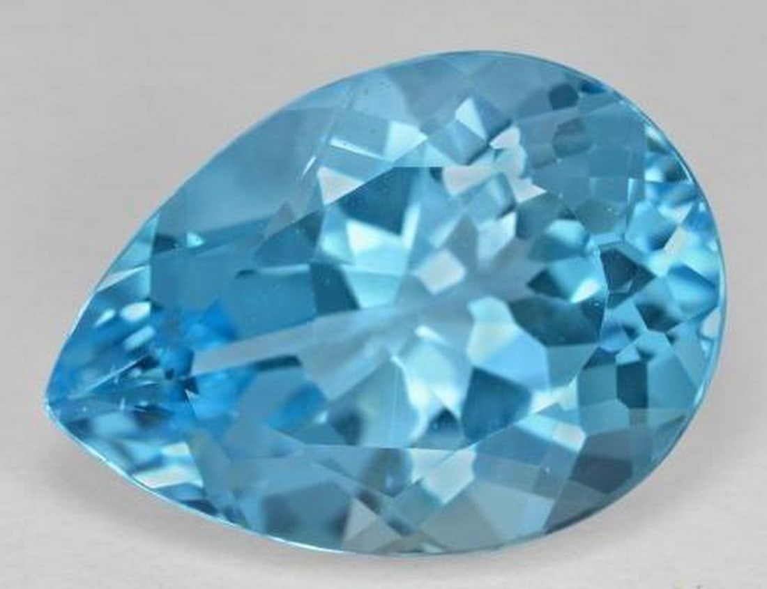 18.96 ct Natural Swiss Blue Topaz, Pear Facet, VVS - VS, Brazil: 18.96 ct Natural Swiss Blue Topaz, Pear Facet, VVS - VS, Brazil Natural topaz weighing 18.96 carats, cut in a pear facet with vivid Swiss blue color. The gem measures 19.86 x 14.26 x 9.95 mm