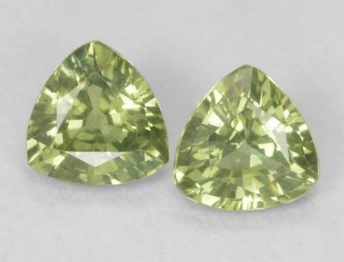 0.68ct Natural Earth Green Sapphires, Trillion Cut, VS, Madagascar: 0.68ct Natural Earth Green Sapphires, Trillion Cut, VS, Madagascar Pair of natural sapphire gemstones with a combined weight of 0.68 carats (average 0.34 carats each), cut in a trillion facet shape wi