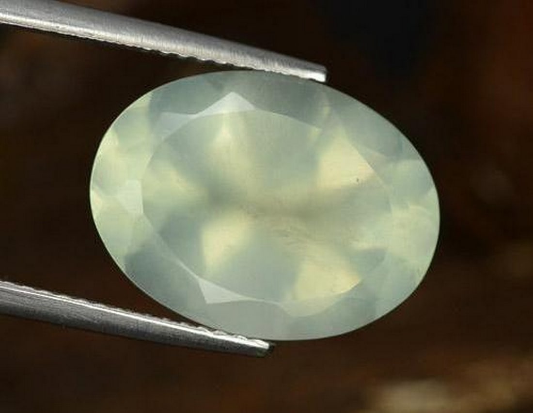 9.30 ct Natural Light Yellow Green Prehnite, Oval Facet, Translucent, South Africa: 9.30 ct Natural Light Yellow Green Prehnite, Oval Facet, Translucent, South Africa Natural Prehnite gemstone weighing 9.30 carats, cut in an oval facet shape with a light yellow-green color and transl