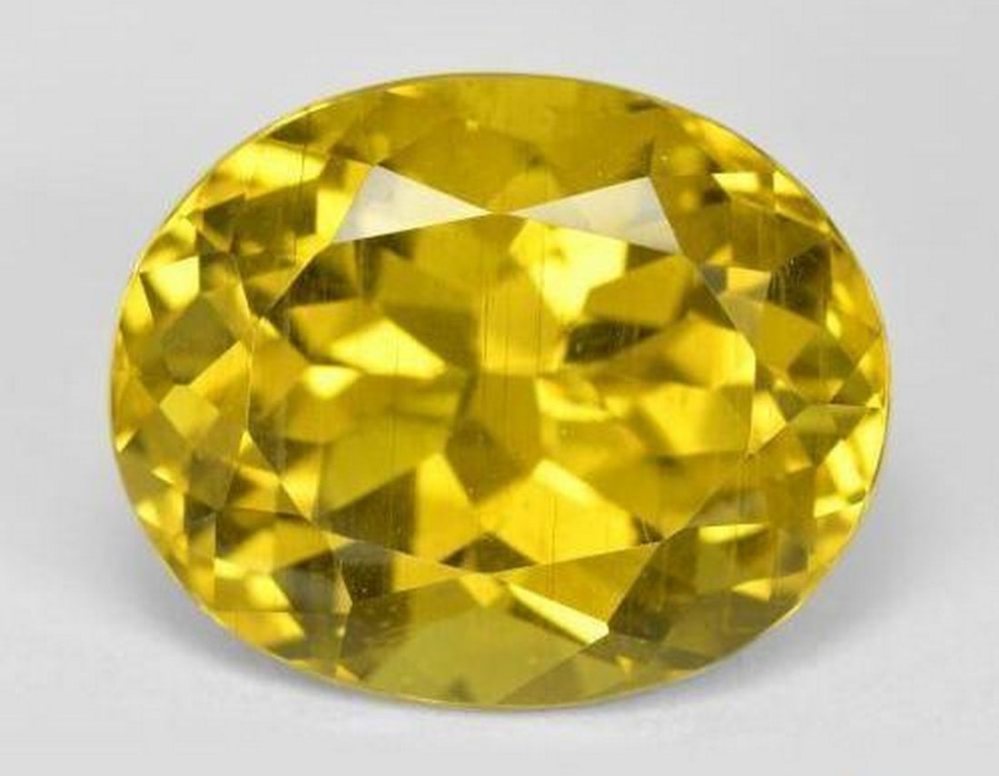 14.76ct Natural Dijon Yellow Apatite, Oval, VS: 14.76ct Natural Dijon Yellow Apatite, Oval, VS A striking natural apatite weighing 14.76 carats, cut in an oval facet with a rich dijon yellow hue and eye-clean VS clarity. Measuring 16.49 x 13.50 x 1
