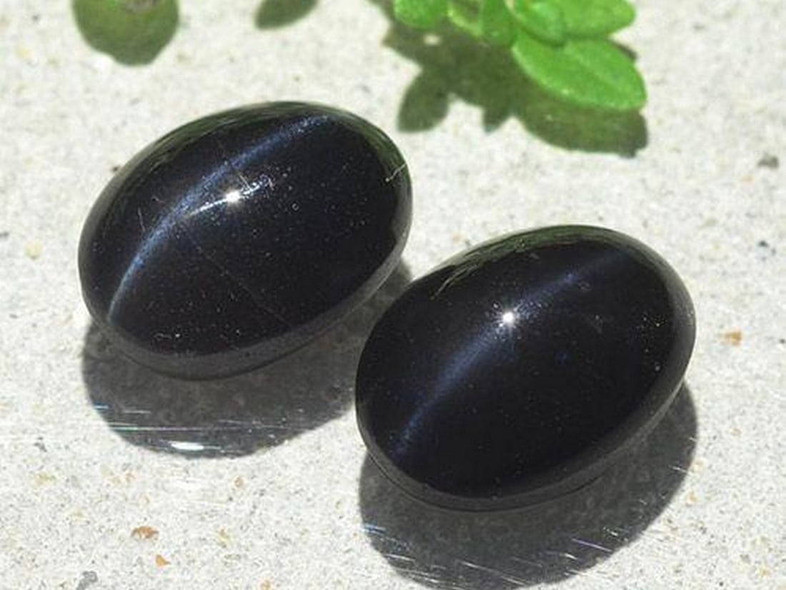 6.03ct Natural Black Cat's Eye Scapolite Gems, Oval, Translucent: 6.03ct Natural Black Cat's Eye Scapolite Gems, Oval, Translucent Pair of natural black cat's eye scapolite gemstones with a combined weight of 6.03 carats (average 3.02 carats each), cut in an oval ca