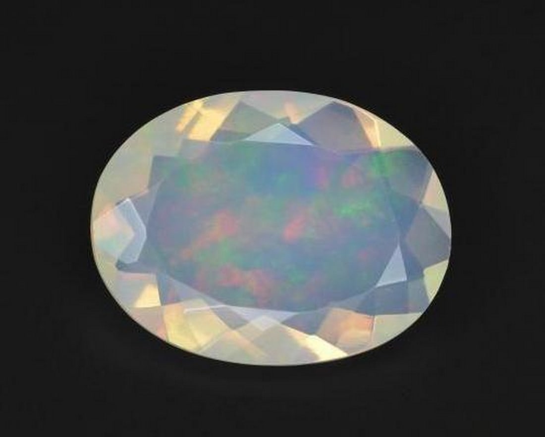 2.21ct Natural Multicolor White Opal, Oval, Transparent: 2.21ct Natural Multicolor White Opal, Oval, Transparent A natural multicolor white opal gemstone weighing 2.21 carats, cut in an oval facet shape with transparent clarity. The gem measures approximate